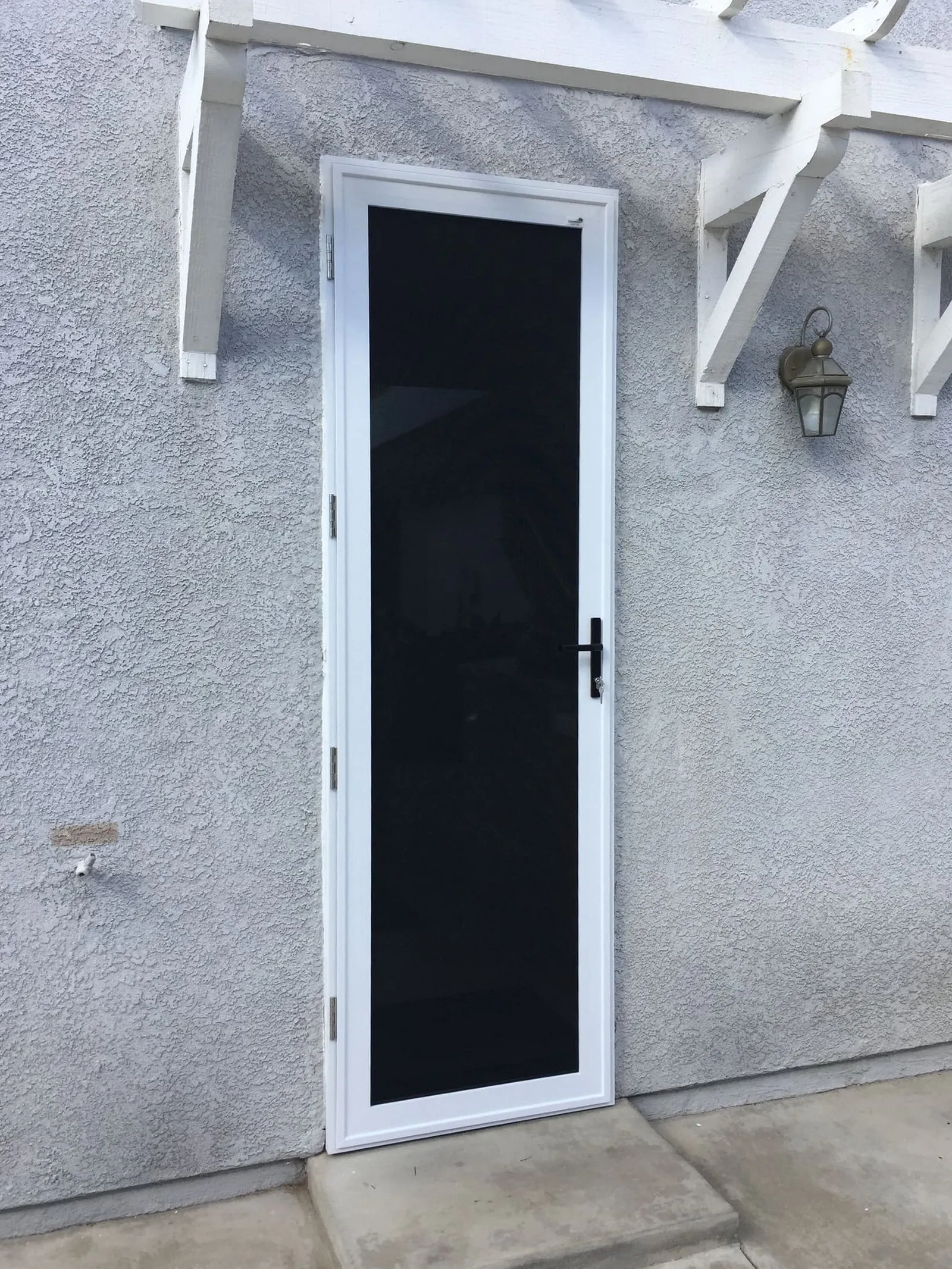 The same entry fitted with a white full-view security screen door