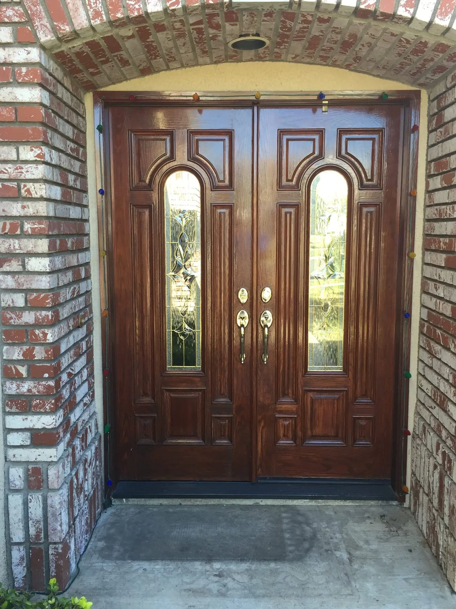 The same brick-arched entry before installation - wooden double doors that stayed closed